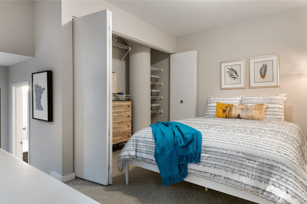a bedroom with a bed and a closet  at The Cosmopolitan, St Paul