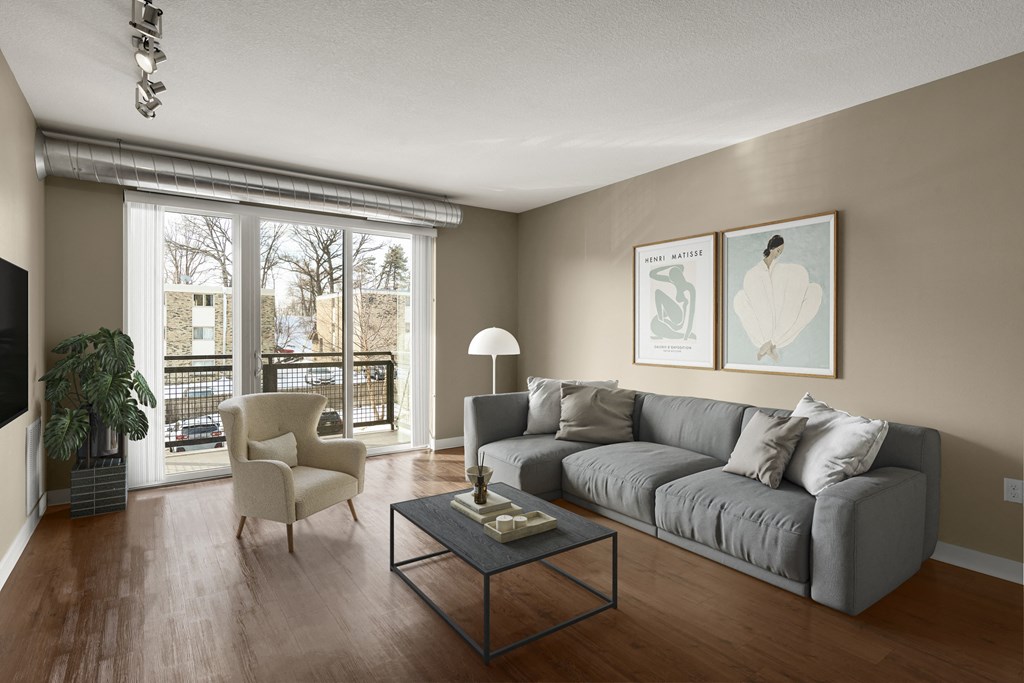 a living room with a large window and a couch at Be @ Axon Green, Minneapolis, MN