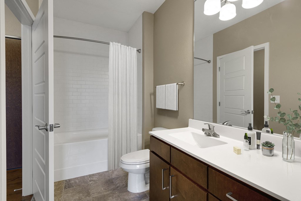 a bathroom with a shower toilet and sink at Be @ Axon Green, Minneapolis, MN