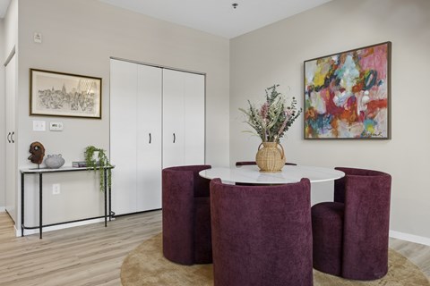Dining room at The Ellory. A dining room with a white table and burgundy chairs.