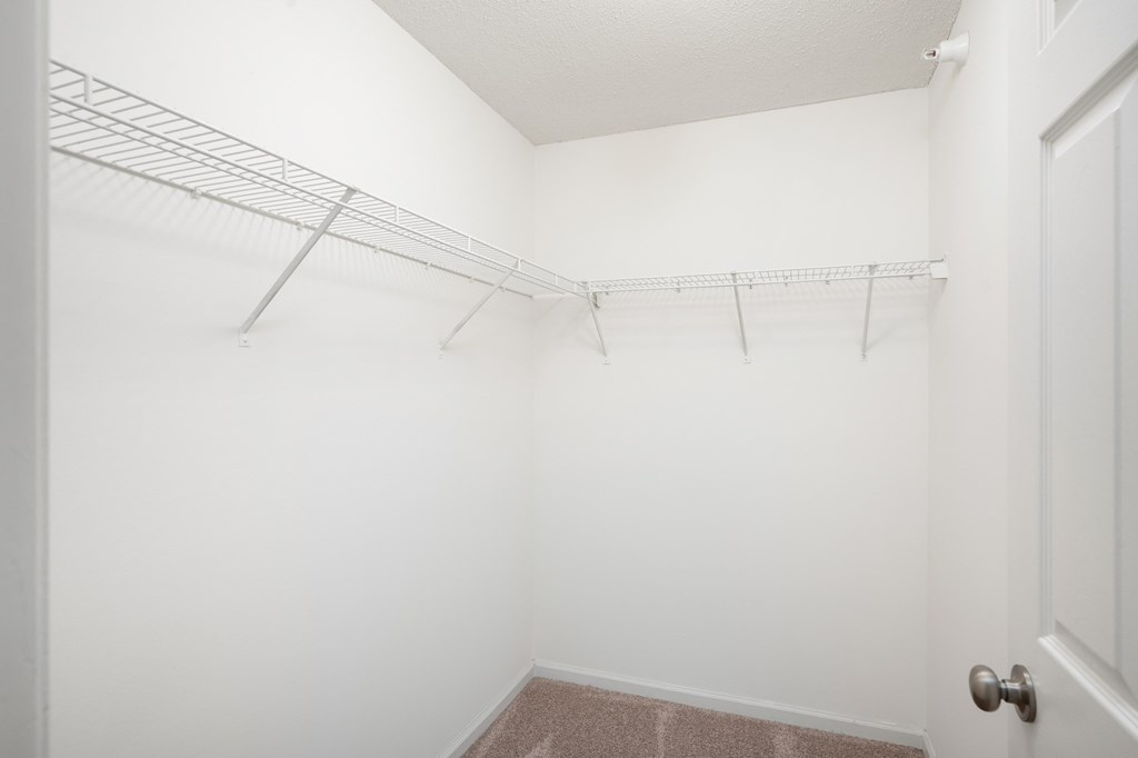 an empty closet with a metal rack on the wall at Cityscape, St Louis Park, MN, 55416