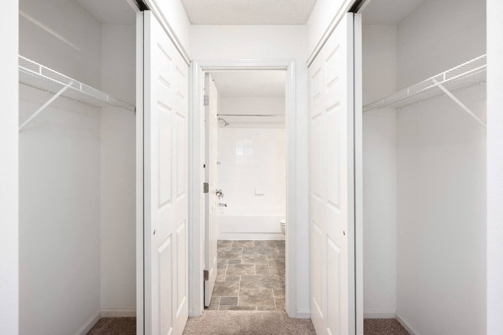 a closet in a bedroom with white doors at Cityscape, St Louis Park, MN, 55416