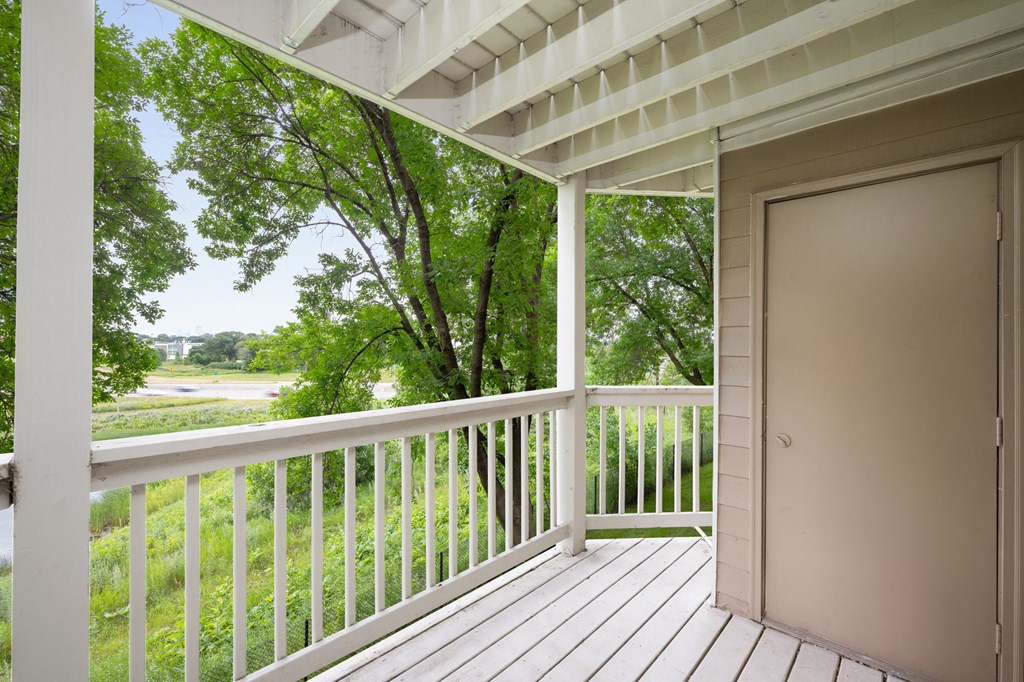 the view from the deck of a house with a door open to a porch at Cityscape, St Louis Park, 55416