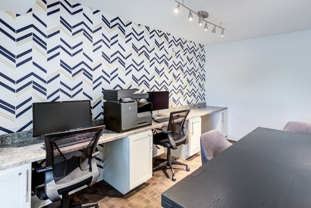 an office with desks and chairs and a wall with a checkered wallpaper at Cityscape, St Louis Park, MN