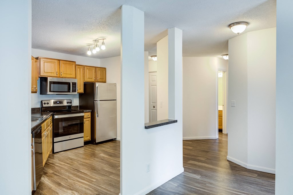 a renovated kitchen with wood flooring and stainless steel appliances at Cityscape, St Louis Park, MN