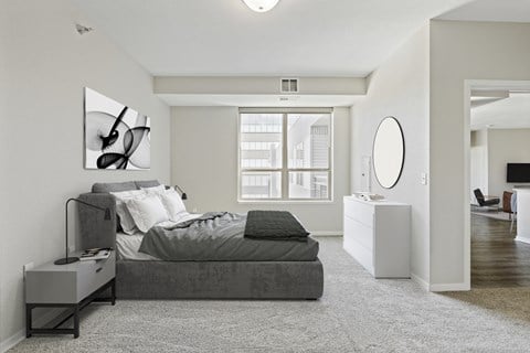 a bedroom with a bed and a dresser and a window