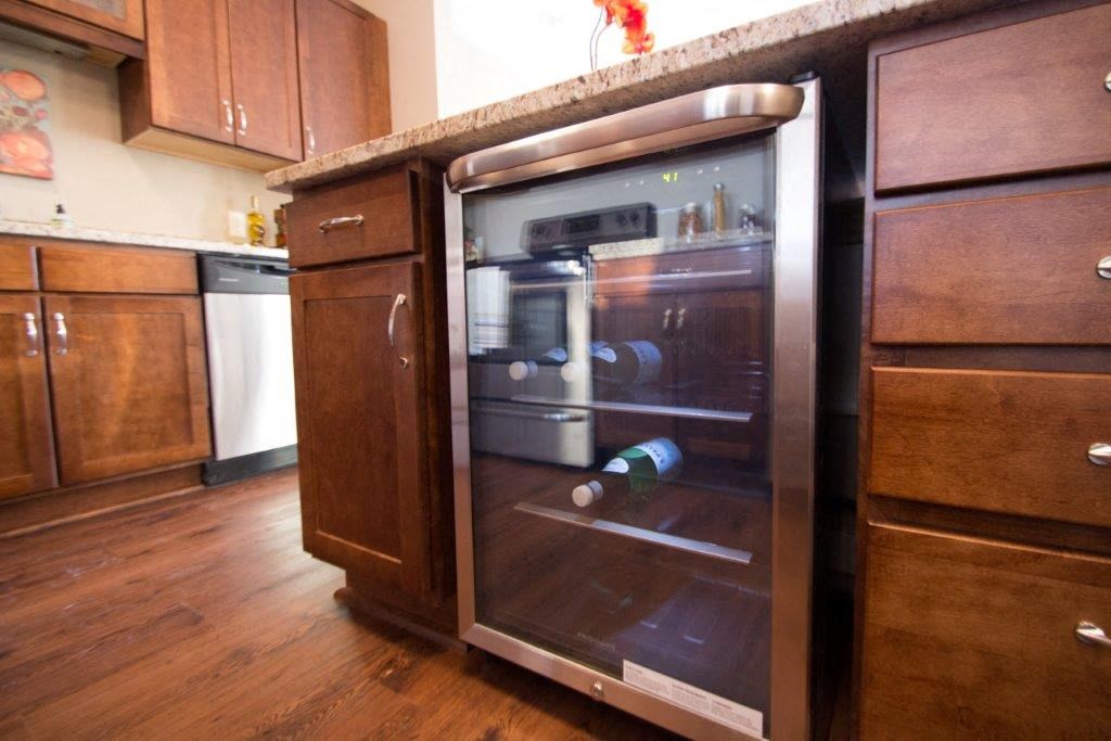 an oven in a kitchen with wooden cabinets