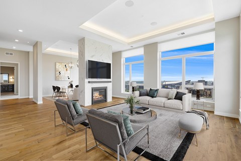 a living room with a couch and chairs and a fireplace