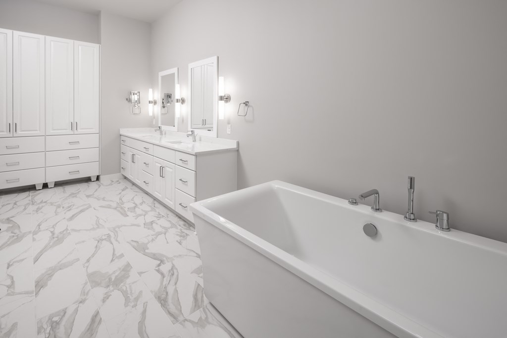 a large white bathroom with a tub and two sinks at Expo, Minneapolis, MN
