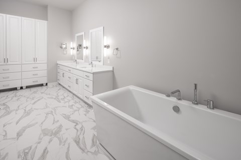a large white bathroom with a tub and two sinks at Expo, Minneapolis, MN