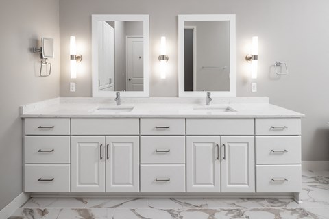 a white bathroom with two sinks and two mirrors at Expo, Minneapolis, 55414