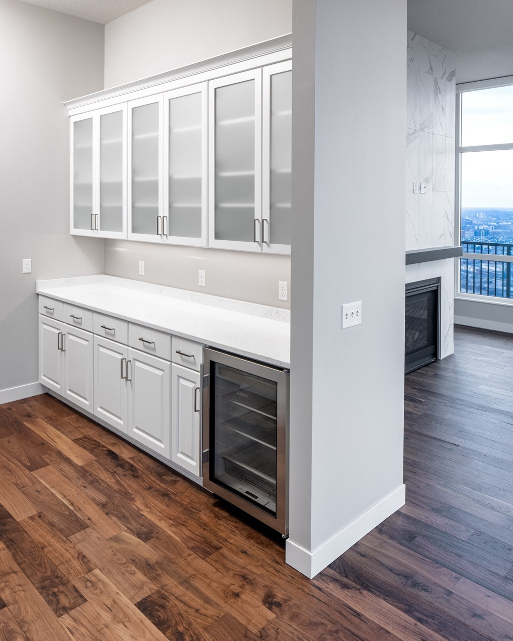an empty kitchen with white cabinets and a wood floor at Expo, Minnesota