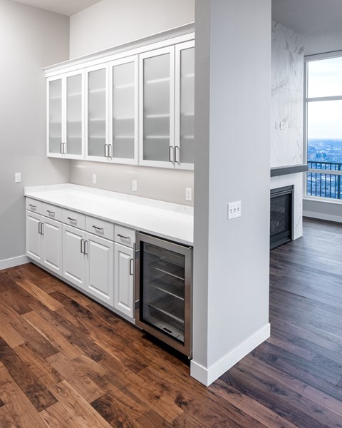 an empty kitchen with white cabinets and a wood floor at Expo, Minnesota