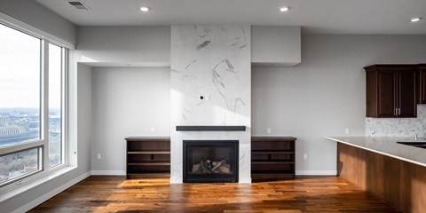 a living room with a fireplace and a large window at Expo, Minneapolis, MN