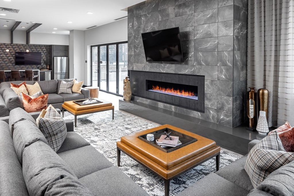 a living room with a gray couch and a fireplace at Expo, Minnesota