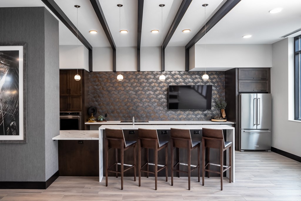 a kitchen with a large island with stools and a tv at Expo, Minnesota, 55414