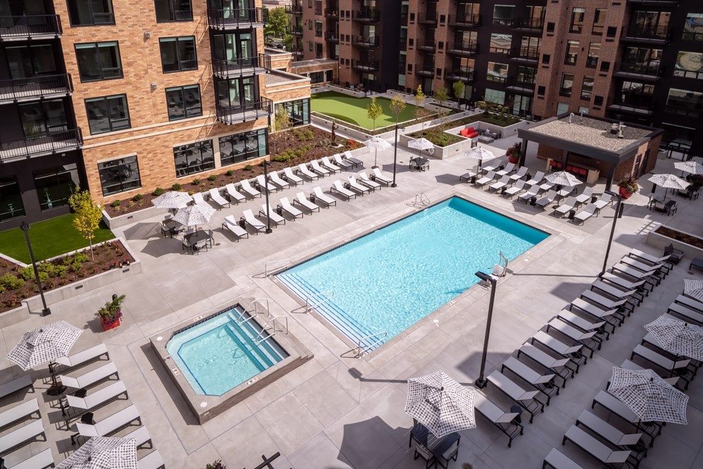 an aerial view of a swimming pool and poolside lounge chairs at an apartment building at Expo, Minnesota 