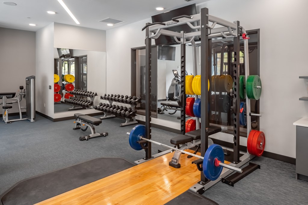 a gym with weights and other exercise equipment on a wooden floor at Expo, Minneapolis, MN 