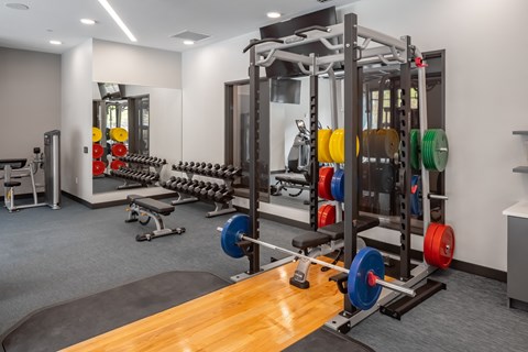 a gym with weights and other exercise equipment on a wooden floor at Expo, Minneapolis, MN