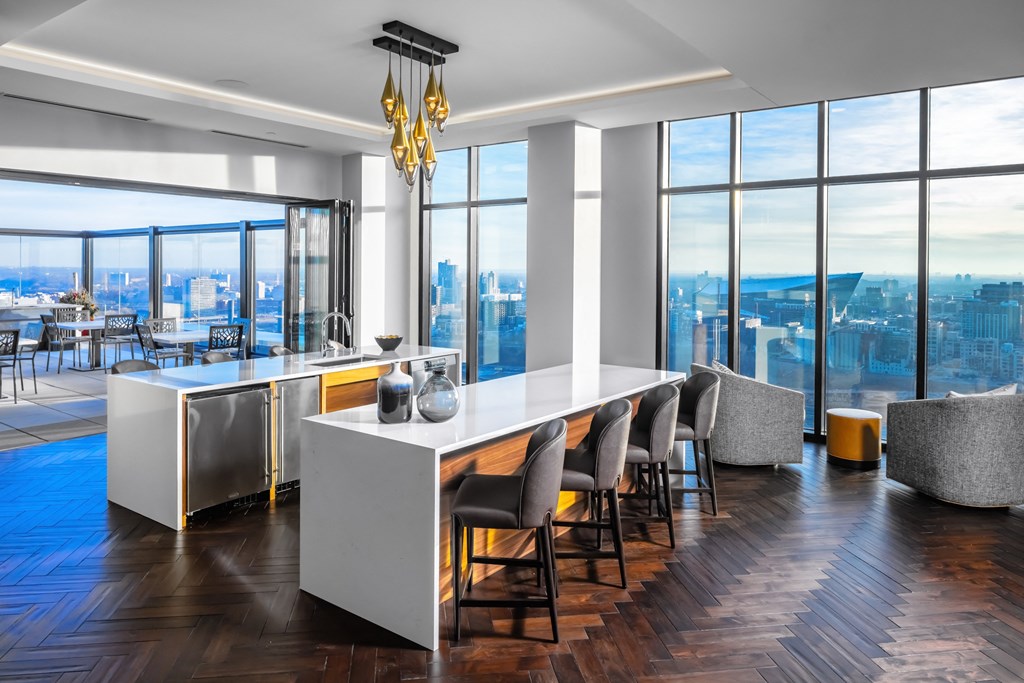 a dining room with a long white table and chairs and a view of the city at Expo, Minneapolis, MN