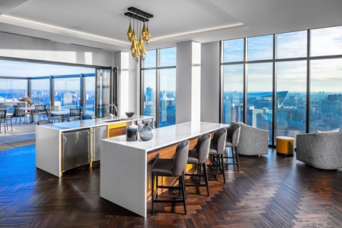 a dining room with a long white table and chairs and a view of the city at Expo, Minneapolis, MN