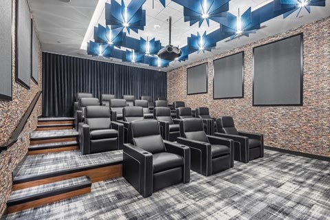 a theater room with chars and a projector screen on the ceiling at Expo, Minneapolis