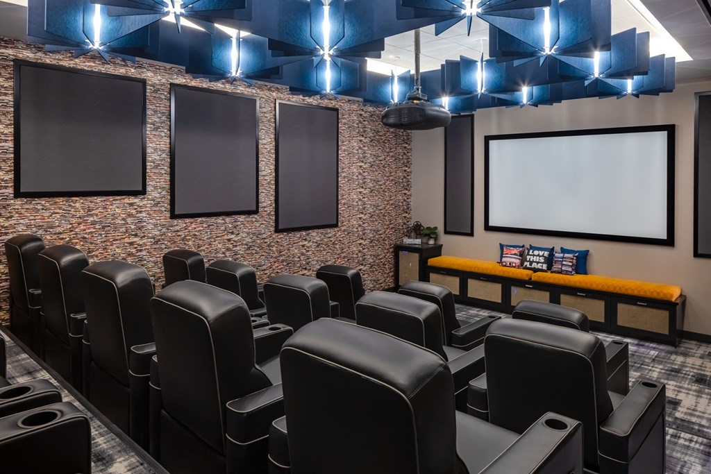 a large screening room with leather chairs and a projector screen at Expo, Minnesota, 55414