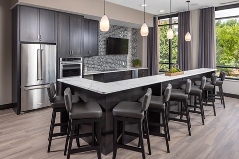 a kitchen with a large island with bar stools at Expo, Minneapolis