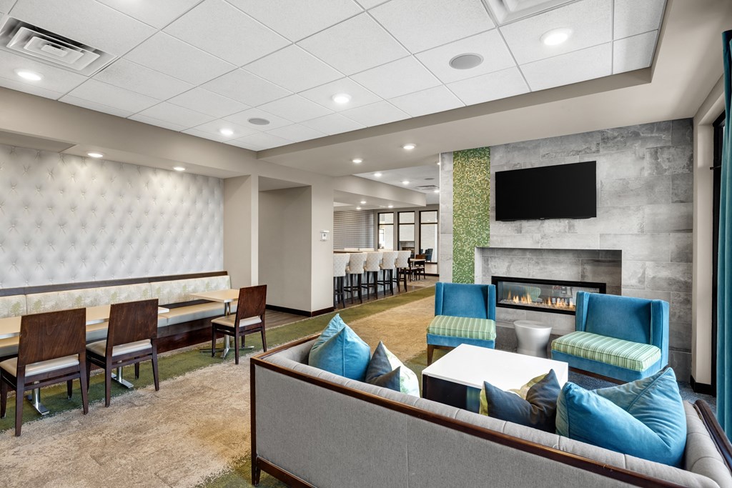 Club Room that has a lounge area with couches chairs and a fireplace at Gabella at Parkside, Minnesota, 55124