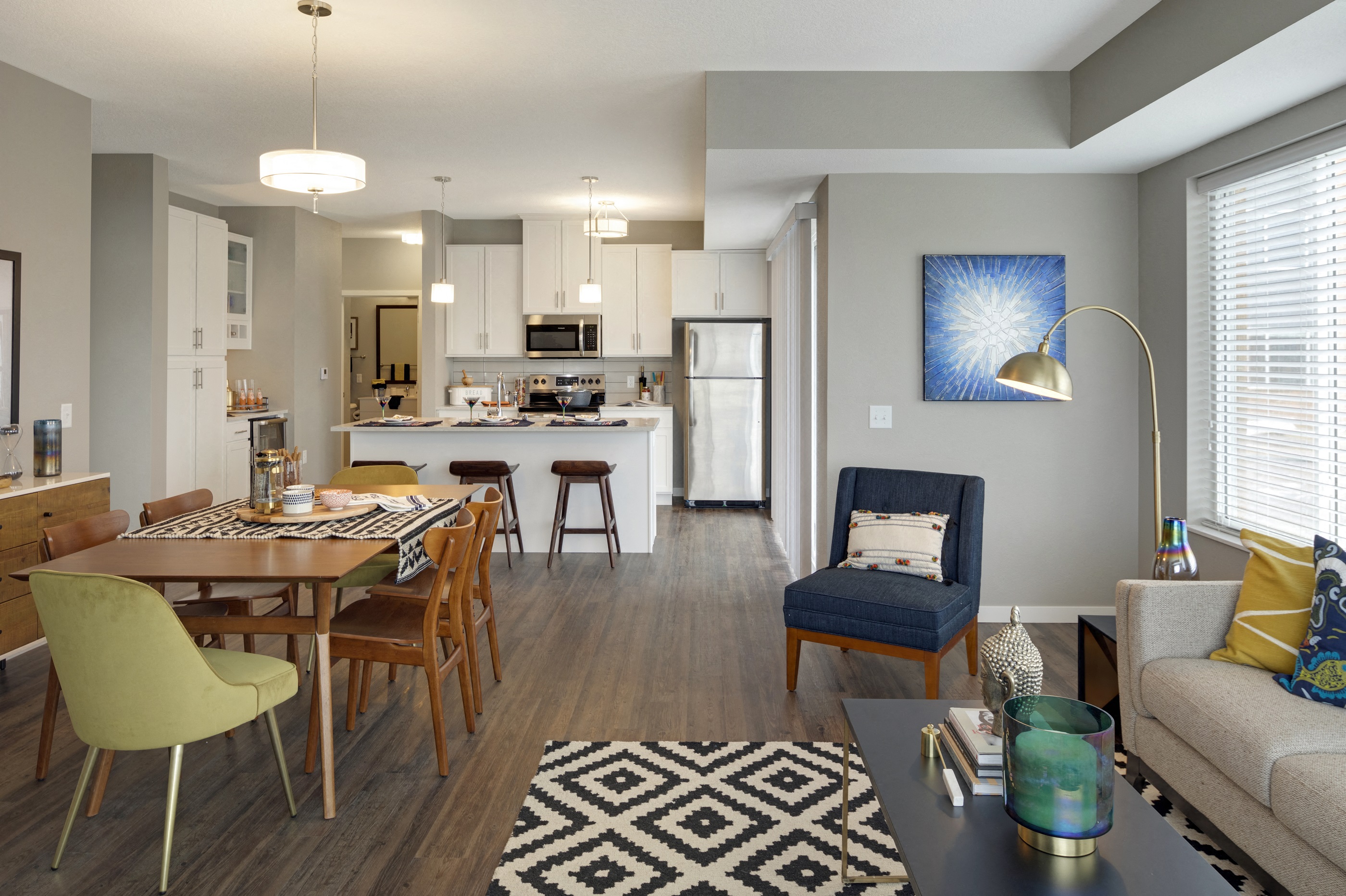 a living room and kitchen with a dining room table and chairs