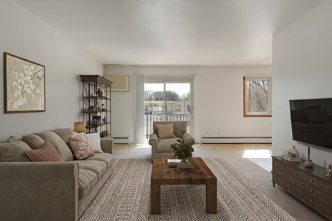 A living room with a grey couch and a wooden coffee table.
