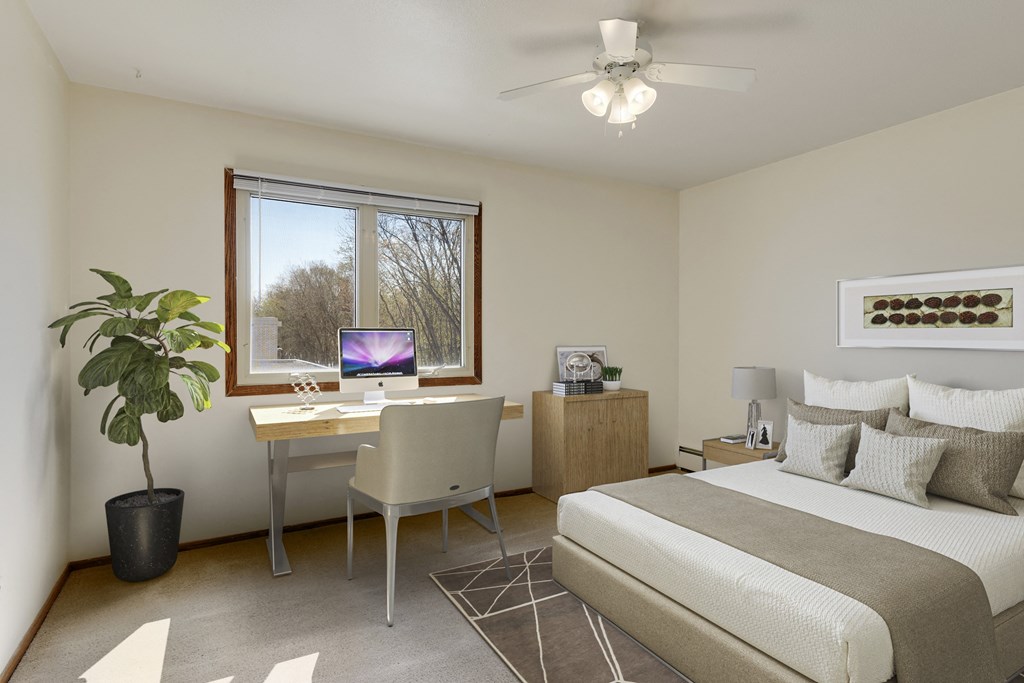 a bedroom with a bed and a desk with a computer at Hamline Terrace, Roseville, MN
