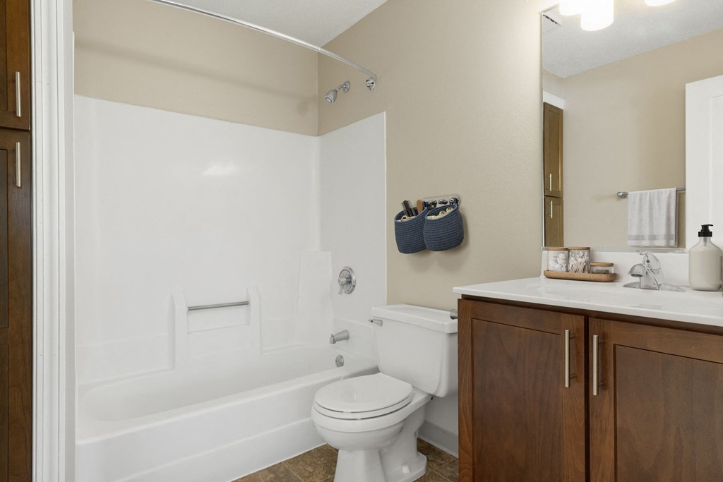 a bathroom with a toilet and a tub and a sink