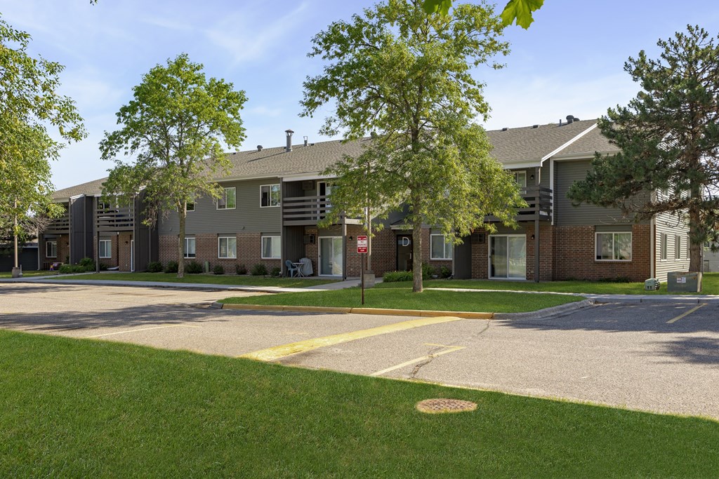 our apartments feature a spacious courtyard with green grass and trees