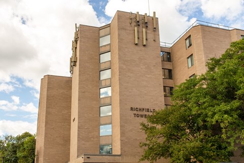 A tall building with the words Richfield Towers on the side.