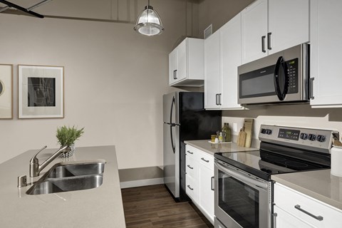 a kitchen with stainless steel appliances and white cabinets