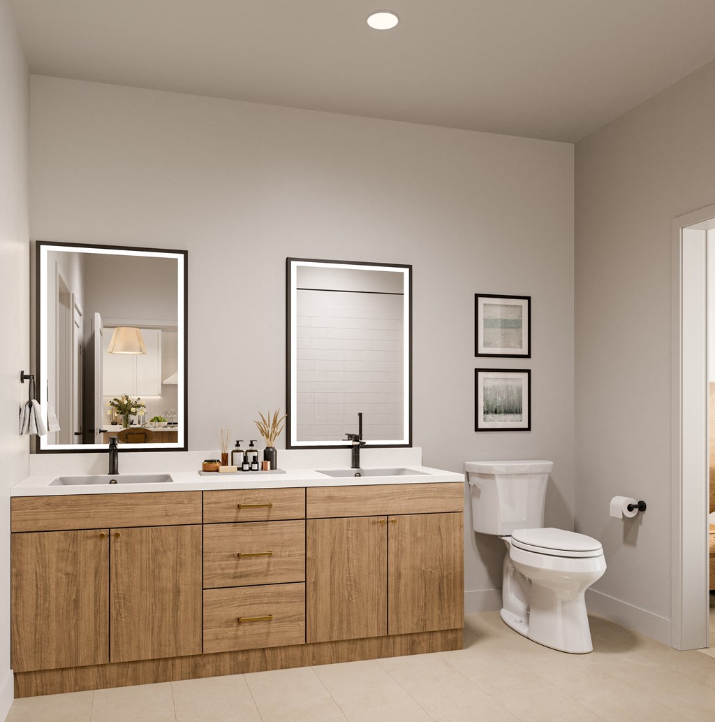 a bathroom with a toilet and a sink and two mirrors at Lilia, Lilydale, Minnesota