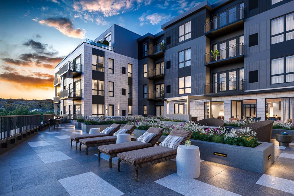a rendering of an apartment building at sunset with lounge chairs
