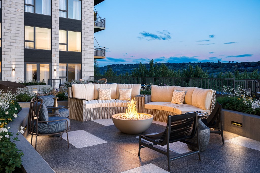 an outdoor patio with a fire pit and furniture