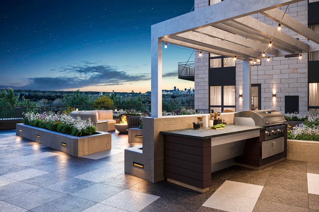 an outdoor kitchen with a view of the city at night