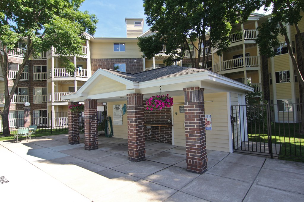 an outside view of an apartment building with a driveway and a gate at Cityscape, St Louis Park, 55416