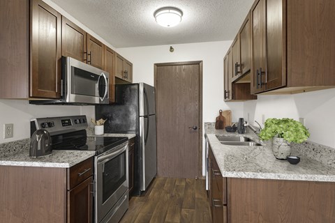 a kitchen with stainless steel appliances and granite counter tops