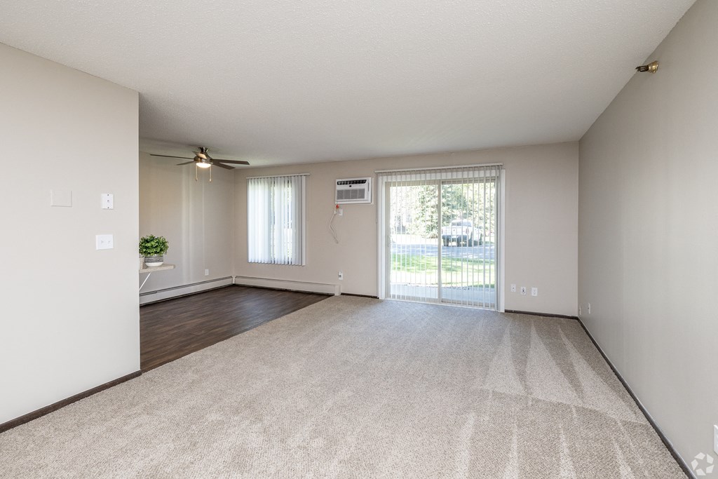 an empty living room with a sliding glass door at Lou Park, St. Louis Park
