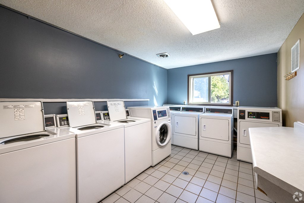 a laundry room with lots of washes and dryers at Lou Park, St. Louis Park, 55426