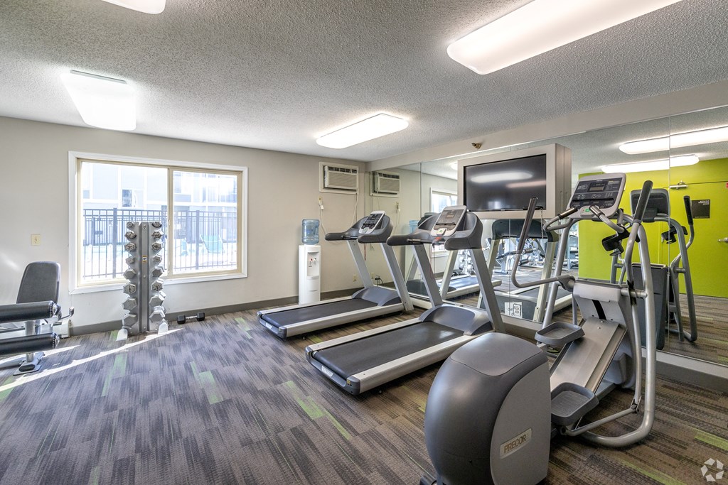our gym is equipped with cardio equipment and a flat screen tv at Lou Park, Minnesota, 55426