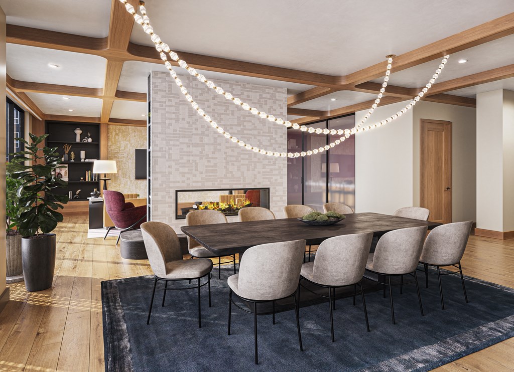 a dining room with a long table and chairs and a fireplace at The Mera, St Louis Park, 55426