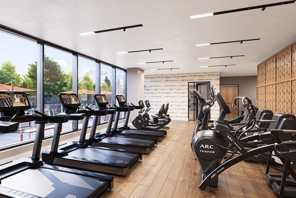 a gym with cardio equipment and large windows at The Mera, St Louis Park