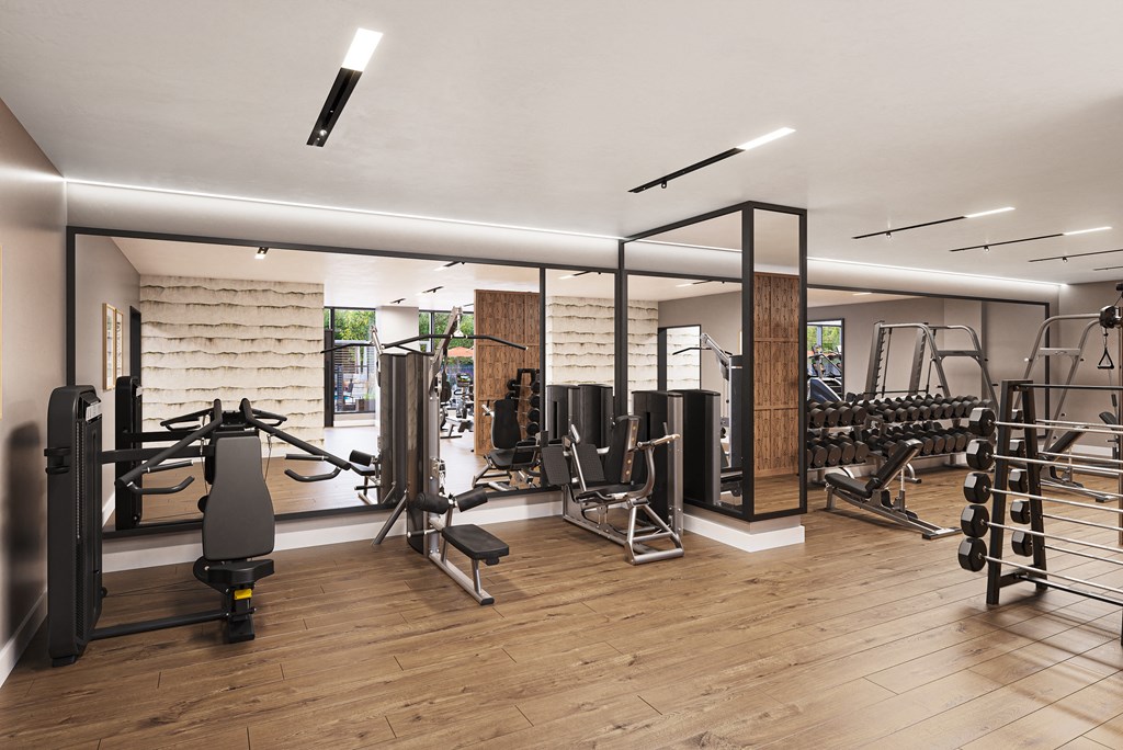 a gym with weights and other exercise equipment on a wooden floor at The Mera, St Louis Park Minnesota