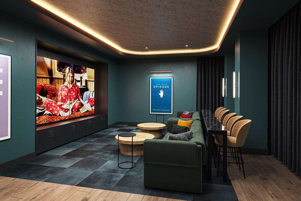 a room with a couch and tables and a large screen on the wallat The Mera, St Louis Park, MN