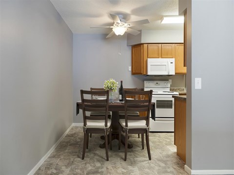 a kitchen and dining room with a table and chairs